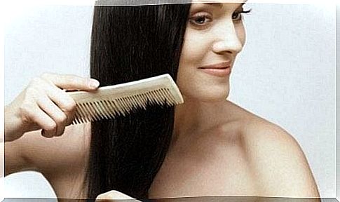 Woman combing her hair to prevent it from falling