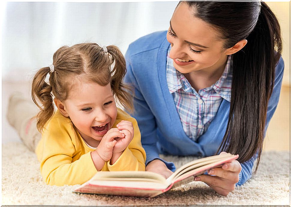 Mother encouraging her daughter's love of books 