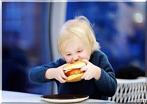 child eating hamburger