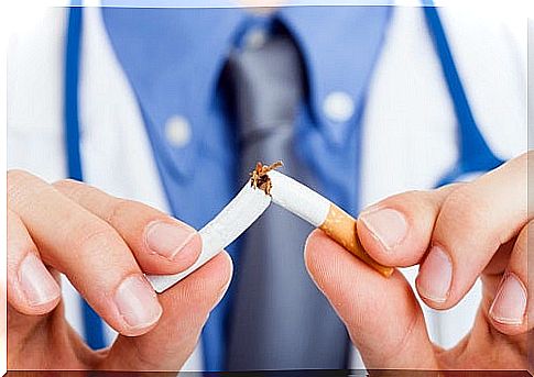 Doctor breaking cigarette in half