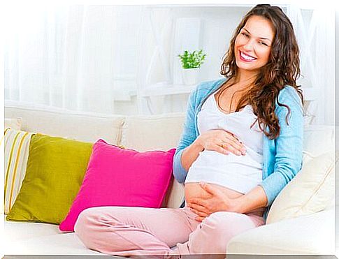 pregnant woman sitting on the sofa